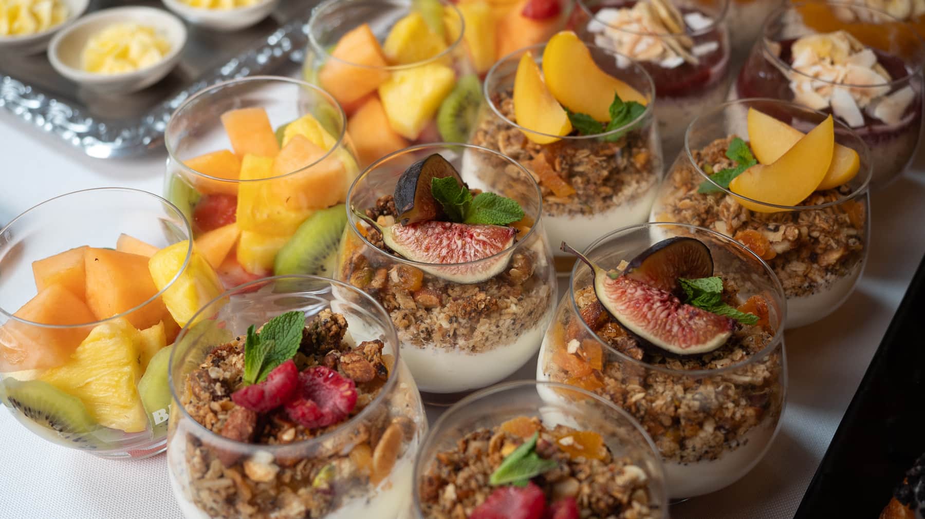 Yoghurt parfait with fresh figs, granola and seasonal fruit at Italian breakfast